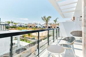 a balcony with chairs and a view of the city at Apartment Comfort Zone 2 in Pilar de la Horadada