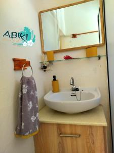 a bathroom with a sink and a mirror at Maya-Abiki Mauritius in Albion
