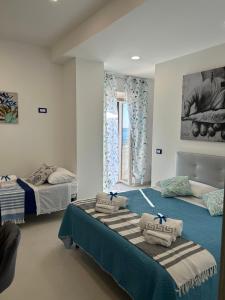 a bedroom with two beds and a window at VistAmare - Fuscaldo in Marina di Fuscaldo