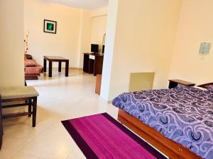 A bed or beds in a room at ArdoVel Park Hotel