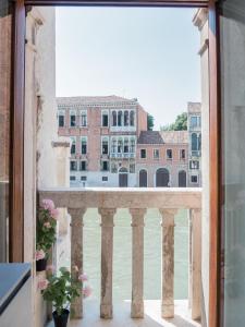 a view from the balcony of a building at Palace Canal View by Wonderful Italy in Venice