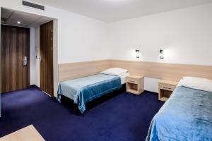 Łóżko lub łóżka w pokoju w obiekcie Centralny Ośrodek Sportu - Szczyrk