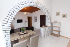 a living room with an archway and a table and chairs at Apartments Ines in Kanfanar