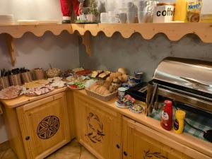 a kitchen with a counter with food on it at Pod Wyciągiem Harenda in Zakopane