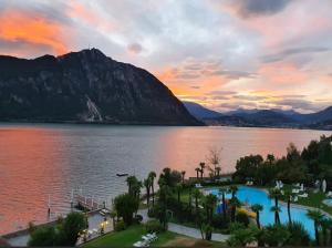 einen Blick auf einen See mit einem Berg im Hintergrund in der Unterkunft Holiday On The Lake Lugano 6 in Bissone