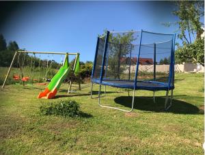 a playground with two swings and a slide at Chambres d hôtes 