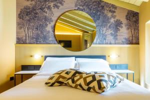 1 dormitorio con 1 cama con espejo en la pared en Albergo La Braseria, en Osio Sotto