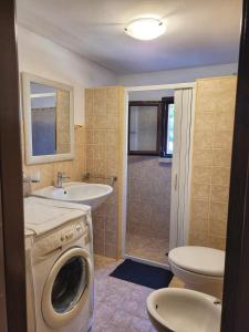 a bathroom with a washing machine and a sink at Gallipoli lato sudChalet Pesco in Taviano