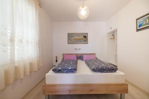 a bedroom with a bed in a room at Apartments Lovorik in Krk