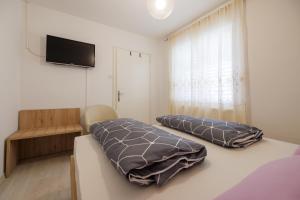 Posteľ alebo postele v izbe v ubytovaní Apartments Lovorik