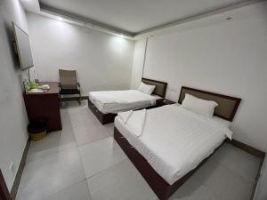 Postel nebo postele na pokoji v ubytování Yaou Hotel