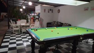 a living room with a pool table in a room at Pai Family House in Pai
