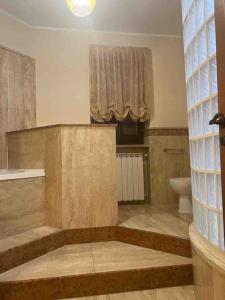 a bathroom with a tub and a toilet and a window at Villa D&C casa affitto breve in Frattaminore +38 photos