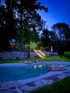 a swimming pool in a yard at night at Agriturismo I Prati di Venere in Sesta Godano