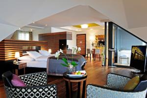 a hotel room with a bed and a living room at Art Deco Hotel Montana Luzern in Luzern