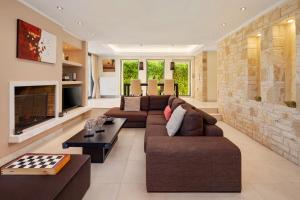 a living room with two couches and a checkerboard at Villa Serena, Eastern Corfu in Kato Korakiana