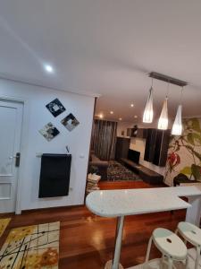 a living room with a table and a couch at Bajo con Jardin en Cartes in Cartes +6 photos