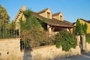 una casa con una valla y plantas en ella en VILLA TAMARIT, en Pedralba