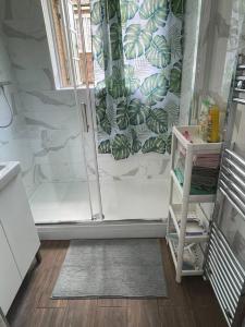 a bathroom with a shower with a glass door at Harrow Town Centre 3 Bed Flat - Sleep up to 5 people, close to London Underground in Harrow