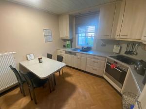 a kitchen with a table and a table and a table and chairs at Fischerdorf-Fewo in Kalkar