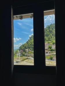 a window with a view of a mountain view at White House Berat in Berat