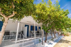 a row of trees in front of a building at Zante Riva Studios in Lithakia