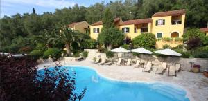 a resort with a swimming pool and a building at Andrikos Studios in (( Kalodhikátika )) +47 photos