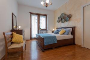a bedroom with a bed and a chair at La Casa di Vitto by Wonderful Italy in Turin