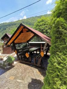 a small building with a roof on a patio at Shelby Accommodation -Adult Only- in Sinaia