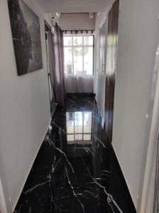 a hallway with a black marble floor at Apartman Selce in Selce