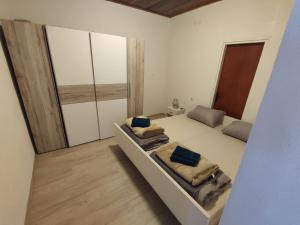 a bedroom with two beds and a large window at Apartman Selce in Selce