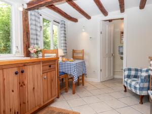 a kitchen with a table and chairs in a room at Shillings Cottage in Cullompton