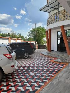 a car parked in front of a building with a rug at Villa Martis Kakamega in Kakamega