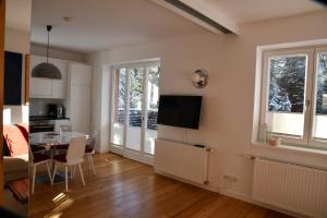 a living room with a table and a dining room at Serpentin Apartment in Turracher Hohe