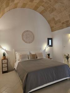 a bedroom with a large bed in a room at Vecchia Mottola Albergo Diffuso in Mottola
