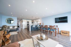 a living room with a couch and a dining room at Beach View Breeze Family Holiday Home on the Shore in Pevensey