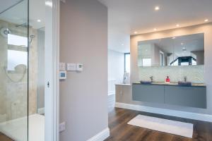 a bathroom with a shower and a mirror at Beach View Breeze Family Holiday Home on the Shore in Pevensey