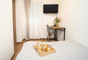 a hotel room with a tray of fruit on a bed at Downhill Apartment on the Groundfloor in Kaunas
