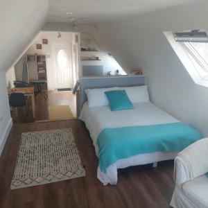 a bedroom with a bed in a attic at Tobar Na Si Apartments in Letterkenny