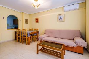 a living room with a couch and a table at San Pascual ID91 in Torrevieja