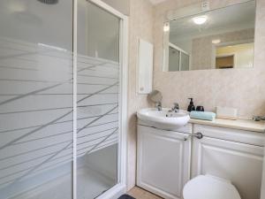 a bathroom with a shower and a toilet and a sink at 122 Morton Road in Lowestoft