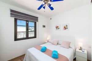 a bedroom with a bed and a window at Blue Beach in Tías