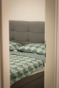 a bed with two pillows on top of it at Apartment Marco in Čapljina +7 photos