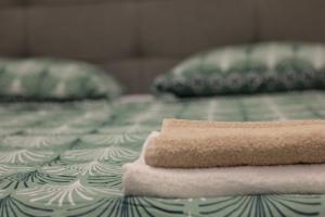 a pile of towels sitting on top of a bed at Apartment Marco in Čapljina
