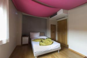 a bedroom with a bed with a purple ceiling at Albergo La Braseria in Osio Sotto