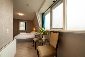 a small room with a bed and a window at Hof van Schoorl in Schoorldam