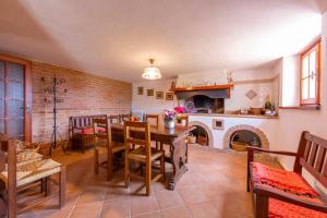 a dining room with a table and a fireplace at Villino Di Corsanico With View - Happy Rentals in Massarosa