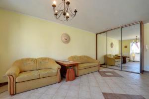 a living room with two couches and a table at Apartamenty Sun Seasons 24 - Portowe in Kołobrzeg