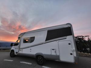 a white camper van parked in a parking lot at autocaravana para 6 plazas posibilidad de moverse o dormir in Montcada i Reixac
