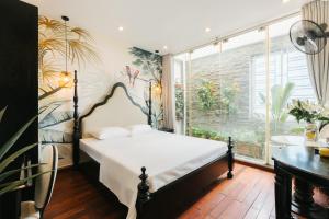 a bedroom with a bed and a window at Sun Clover Boutique Hotel in Hanoi